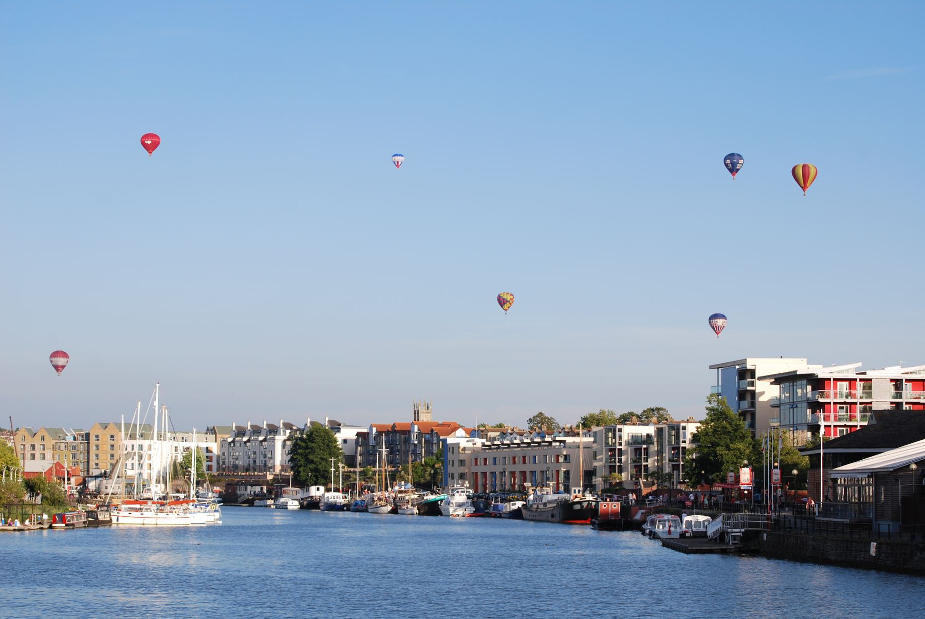 Hot air balloons rising over Bristol's floating harbour