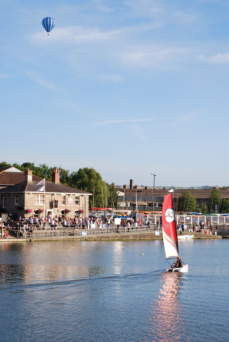 Boats and crowds along Bristol harbourside on a sunny day